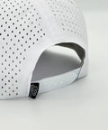 Back view of Performance Golf Hat With Breathable Laser Holes And Adjustable Strapback For A Sharp Witty On Course Look Dope Polyester Build In Crisp White.