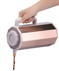 Hand pouring coffee from Gold Glass Vacuum Carafe 1.0 Liter Insulated Bottle With Premium Borosilicate Glass Liner