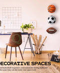 Heavy Duty 4 Pack Wall Mount Ball Rack Set Universal Metal Storage Holder For Basketball Football Volleyball Soccer Space Saving Black Racks Rust Resistant Holds Up To 30 Lbs Each Easy Mounting Screws Included displayed in a modern room holding basketball, soccer ball, and football.