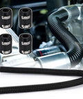 Black flexible radiator coolant hose kit with four metal clamps, coiled in foreground against engine bay.