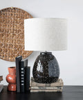Stoneware Table Lamp In Black And White For Nightstands And Desks with white shade and black base on dresser.