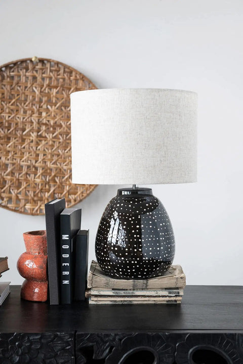 Stoneware Table Lamp In Black And White For Nightstands And Desks with white shade and black base on dresser.