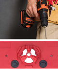 Red woodworking hinge drilling jig with 35mm hole saw, cordless drill in hand.