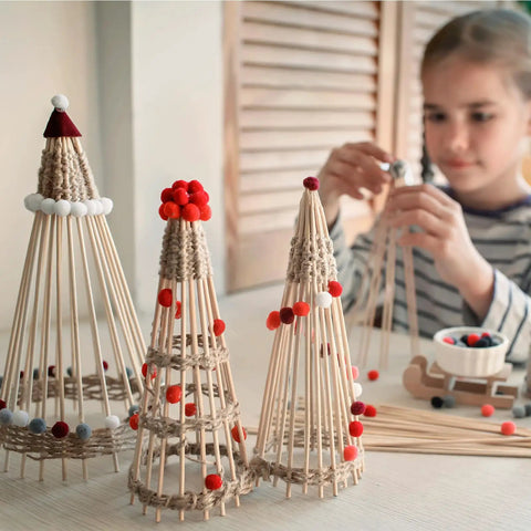Top Shelf Unfinished Round Wooden Dowel Rods 1/4 X 18 Inch Birch Craft Sticks For Diy Projects And Home Decor 50 Pack assembled into decorative trees with pom poms.