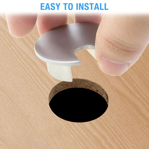 Set Of Two Bronze Desk Grommets Straight Up Sturdy Zinc Alloy Cable Management Covers being installed into desk hole.
