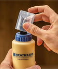 Handy Wood Glue Applicator Tips Featuring Durable Silicone Nozzles And Secure Plastic Collars For Super Smooth Box Joint Assembly Includes Protective Caps And Quick Cleanup Brushes For No Sweat Adhesive Control being placed on a glue bottle.