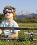 Child with RC plane featuring Six Pack 7x5 Inch RC Propellers With 2 Vane Blades Gray Includes Adapter Rings For RC Airplane Replacement