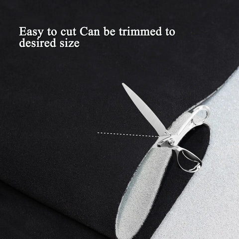 Suede headliner fabric with foam backing, black, 96 x 60 in, automotive interior roof material; close-up with scissors