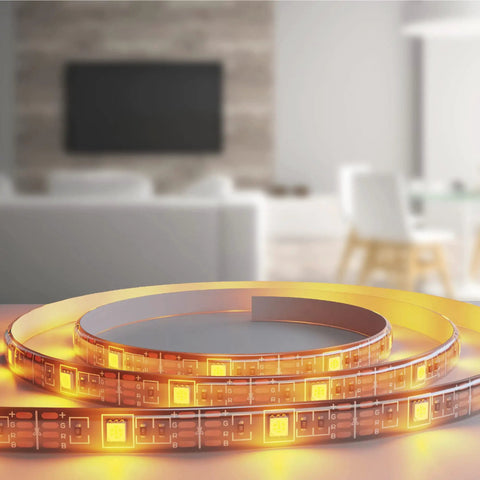 Close-up of Smart Multicolor LED Light Strip 6.5 Feet with App Control and Dimmable Color Changing Lighting on table
