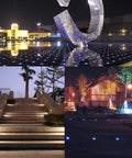 Outdoor scene with 16 Pack Recessed LED Deck Lights 32mm Step Lights illuminating stairs and pathways, creating a modern look.