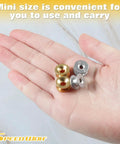 Hand holding brass and aluminum eyelets from 12 Pcs Grass Trimmer Eyelets Kit With Plastic Storage Box For String Trimmers Brass And Aluminum Eyelets Replacement Parts For Garden Tools Brush Cutters And Engine Trimmers Pro Grade