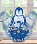 DIY Penguin Soldering Kit With Motion Activated RGB Lights For STEM Education wobbling on a table in front of a window