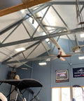 Heavy Duty Led High Bay Light 2 Foot Linear Shop Fixture 200 Watt in a spacious warehouse interior with boats.