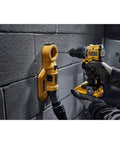 Compact 20V Max Brushless Cordless Hammer Drill With A Rock Solid Ratcheting One Half Inch Chuck And One Thousand Six Hundred Fifty RPM For Tight Spots And Knuckle Bash Work Ready To Roll Tool Only Edition drilling into a masonry wall.