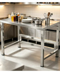 Heavy Duty Stainless Steel Workbench With Beefy Reinforced Crossbars And Folded Safety Edges For Rock Solid Kitchen Prep Or Warehouse Packing Projects in a kitchen with utensils and ingredients.