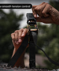 Close-up of hands using Beefy Heavy Duty Ratchet Tie Down Straps 1 Inch By 15 Feet Pack Of 4 With 1823 Lbs Break Strength Black.
