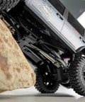 Rock Solid Stainless Steel Drive Shafts For Axial SCX30 Crawler Upgrade under RC truck close to rock obstacle.
