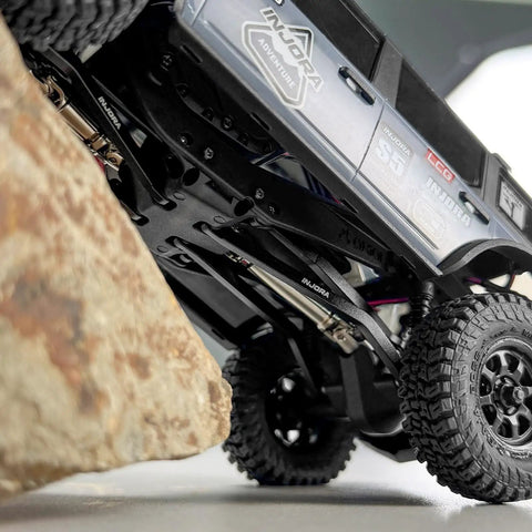 Rock Solid Stainless Steel Drive Shafts For Axial SCX30 Crawler Upgrade under RC truck close to rock obstacle.