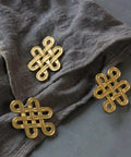 Gold Chinese Knot Cabinet Pull Handle With Single Hole Design For Wardrobes Cabinets And Dressers on fabric
