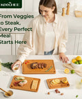 Bamboo Cutting Board Set With Deep Juice Grooves And Built In Handles used for meat, veggies, and charcuterie on a kitchen counter.
