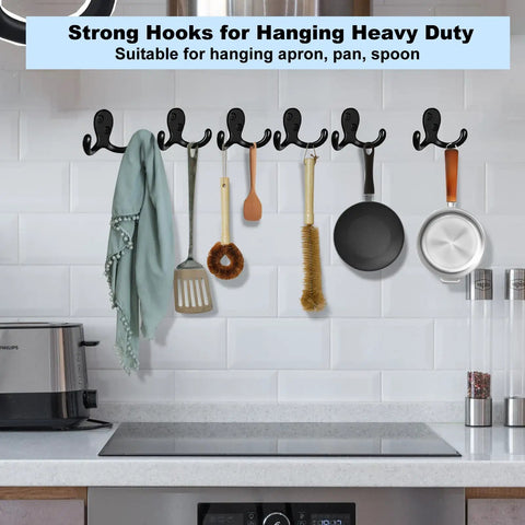 4 Pack Wall Hooks Set, Heavy Duty Metal Coat Hangers In Black, Wall Mounted With Screws, holding kitchen utensils on a white wall