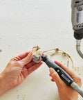 Hands using Top Tier Variable Speed Rotary Tool Kit With Hella Steady Flex Shaft for precision drilling on decorative piece.