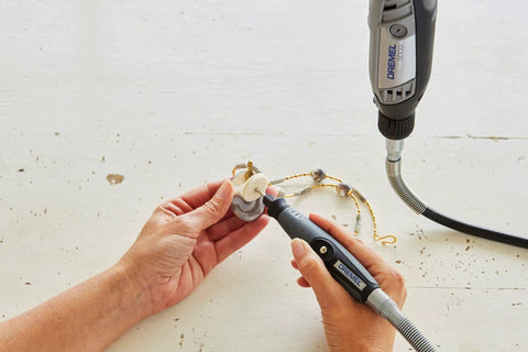 Hands using Top Tier Variable Speed Rotary Tool Kit With Hella Steady Flex Shaft for precision drilling on decorative piece.