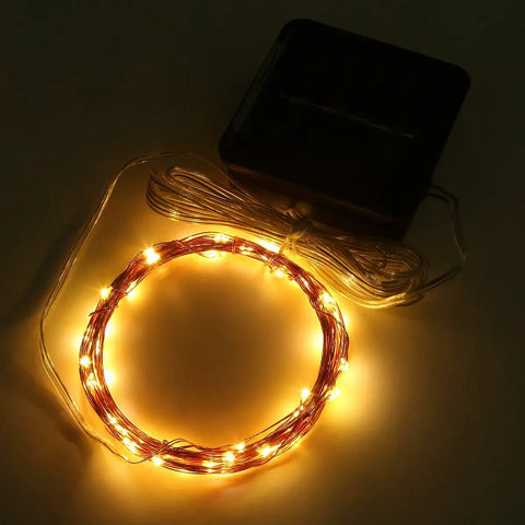 Coiled Solar String Lights 16 Feet 50 LEDs Warm White Two Pack Outdoor Fairy Lights glowing in the dark