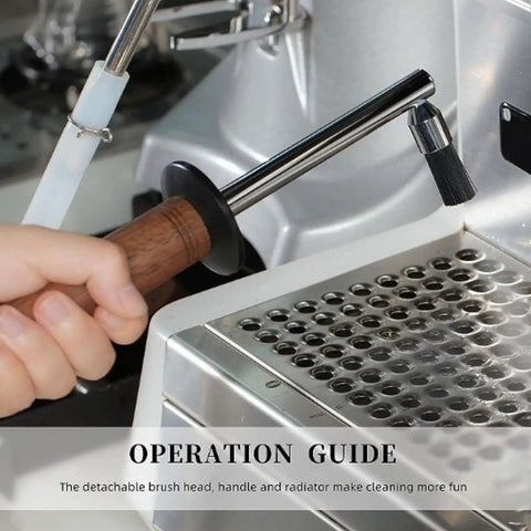 Hand using Commercial Coffee Machine Steam Wand Brush With High Pressure Steam Cleaner Pro Grade Fits Over 10mm Wands Durable Heat Proof Head Deep Clean To Break Down Coffee Oils Milk Fats And Mineral Deposits at work