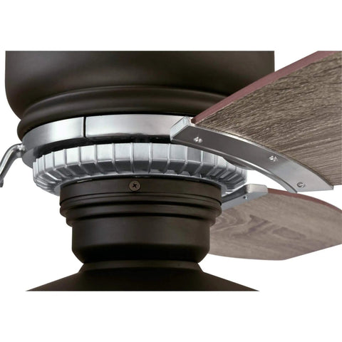 Close-up of Vintage Indoor 54 Inch Ceiling Fan with Light and Remote, weathered bronze two-tone finish blade attachment detail.