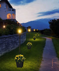 64 Inch Solar Lamp Post With Planter For Garden And Pathway, Waterproof Outdoor Lighting Poles illuminating a curved driveway