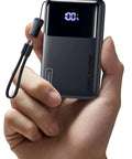 Throw This Compact 10000 Mah Power Bank In Your Pocket For Immediate Relief Packs 45W Usb C Pd Fast Charge For Phones Consoles And Laptops held in hand.