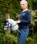 Person holding Hobby Horse Toy Competition Bridle in Black with Padded Leather Browband and Noseband in a garden setting