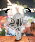 Retro Dynamic Vocal Microphone With Classic Metal Design adjusting angle, shown with blurred outdoor night scene, ideal for live gigs.