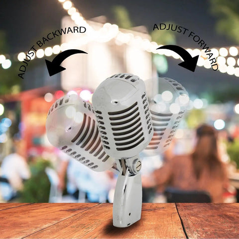 Retro Dynamic Vocal Microphone With Classic Metal Design adjusting angle, shown with blurred outdoor night scene, ideal for live gigs.