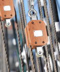 Close-up of Two Pack Four Inch Wood Manila Rope Pulley Block With Hook Single Wheel Cable Pulley in marine setting