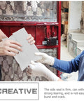 Hands holding a Bulk Pack Water Resistant Self Sealing Shipping Bags 25x30cm Plastic Courier Mailers near a red gate.