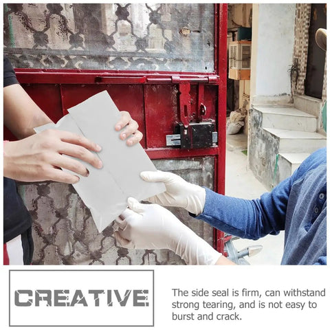 Hands holding a Bulk Pack Water Resistant Self Sealing Shipping Bags 25x30cm Plastic Courier Mailers near a red gate.