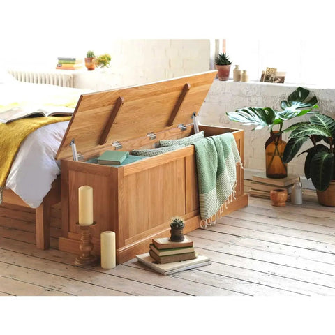 Front view of wooden storage bench with lift-top oak finish; dual gas struts hold the lid open.