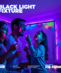 People enjoying a party under Lit Blacklight Strip Lights USB 1ft Bar, 10W, Adjustable UV Glow For Parties, Halloween Decor.