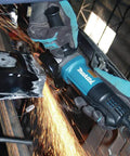 Worker using Paddle Switch 4-1/2 Inch Angle Grinder With 7.5 Amp Power, Workhorse Lightweight 4.5 Lb Tool, Compact 2.5 Inch Barrel Grip