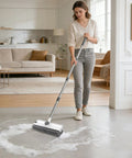 Person using 3 In 1 Floor Scrub Brush With 54 Inch Adjustable Long Handle Scraper And Squeegee, V Brush For Grout on living room floor.
