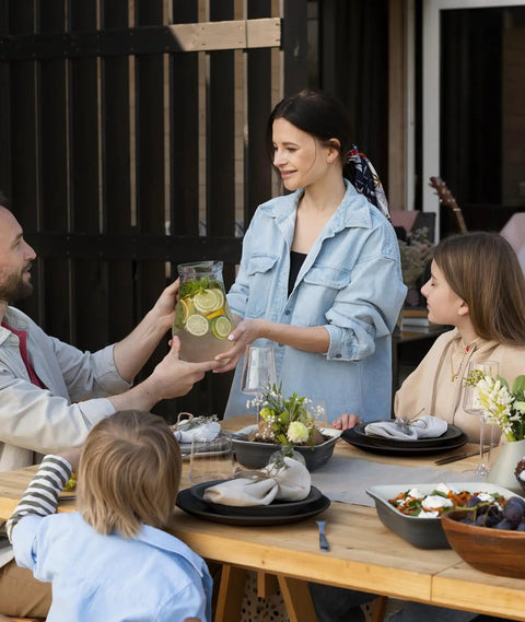 Family using Unbreakable 24 Piece Dinnerware Set For Six With Plates Bowls And Cups at outdoor dining table