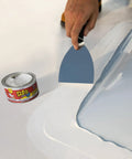 Heavy Duty Rubberized Waterproof Sealant Paste In Bright White Half Quart Tub applied to surface using a scraper tool.