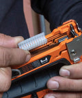 Close-up of Heavy Duty Cable Stapler Built Tough For Voice Data Video And Nonmetallic NM Cable in use with insulated staples and lever.