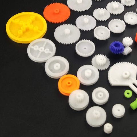 Assorted gears from 82 Piece Plastic Gear Kit For DIY Toy Cars And Robots Complete Gear Pack With Pulleys Racks Belts Bushings Shafts