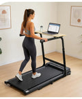 Woman using Walking Pad Desk Attachment With Adjustable Height And Handlebar Two-In-One Laptop Workstation in home office