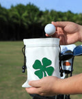 Person holding a Leather Golf Valuables Pouch With Drawstrings, Tee Pouch For Golfers, On The Go Golf Ball Bag For Men And Women with shamrock design