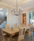 Premium Black Six Light Chandelier Rust Resistant Metal Candle Pendant Fixture For Dining Room Kitchen Modern Farmhouse Ceiling Lamp above a dining table.