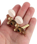 Vintage Carving Ukulele Tuning Pegs And Classical Guitar Machine Heads Replacement Parts, metal and resin pegs in hand